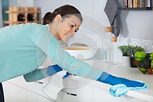 concentrated woman scrubbing bar in kitchen