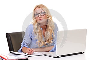 young beautiful businesswoman working on laptop in bright modern office