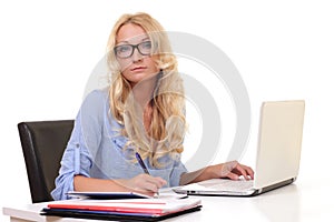 young beautiful businesswoman working on laptop in bright modern office