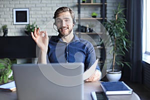 Concentrated young freelancer businessman using laptop for video conferance, working remotely online at home