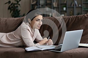 Concentrated young Indian woman studying on online courses.