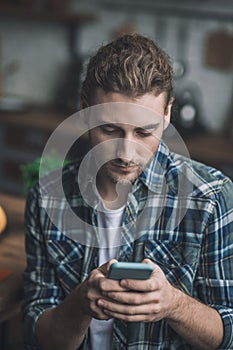 Concentrated young man texting about his business