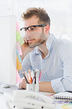 Concentrated young man using computer