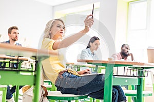 concentrated young students sitting in classroom