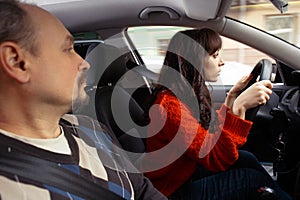 Concentrated young woman driving a car