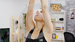 Concentrated young woman relaxing doing yoga exercise