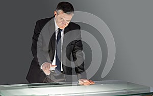 Concentrating businessman leaning on desk