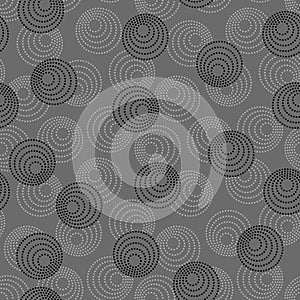 Concentric circles with dotted outline in two colors. Seamless geometric pattern on dark gray background. Vector colorless image