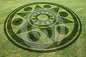 Concentric circles star fake crop circle in the meadow photo
