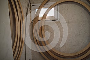 The concentric rings of woodwork, unfinished and stacked, await their transformation into decorative pieces or