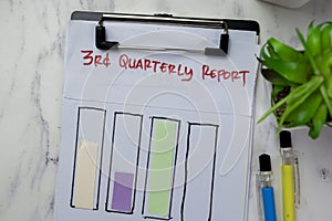 Concept of 3rd Quarterly Report write on paperwork and bar graph isolated on Wooden Table