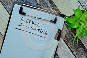 Concept of Accrual Accounting write on paperwork isolated on Wooden Table