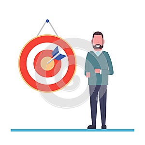 Concept of achieving a goal or success. Man is standing near the target struck by an arrow. Completion of the task. Flat