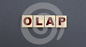 Concept acronym OLAP on wooden cubes on a gray background