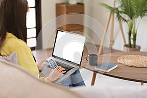 Concept of activity in home, Young woman is chatting with friends on laptop while sitting on couch