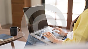 Concept of activity in home, Young woman is chatting with friends on laptop while sitting on couch