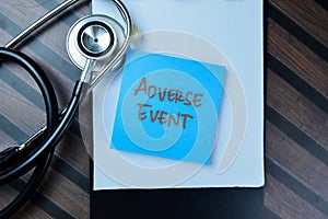 Concept of Adverse Event write on sticky notes with stethoscope isolated on Wooden Table