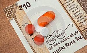 Concept of the affordable medicine in India due to generic drugs on Indian currency notes as background.