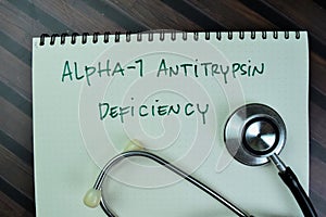 Concept of Alpha-1 Antitrypsin Deficiency write on a book isolated on Wooden Table photo