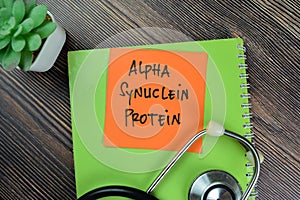 Concept of Alpha Synuclein Protein write on sticky notes isolated on Wooden Table photo