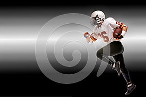 Concept american football, american football player with ball in hand. Black white background, copy space. American