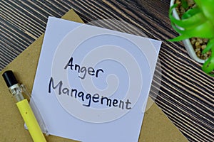 Concept of Anger Management write on sticky notes isolated on Wooden Table