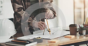 Concept architects, engineer holding pen pointing equipment architects On the desk with a blueprint in the office