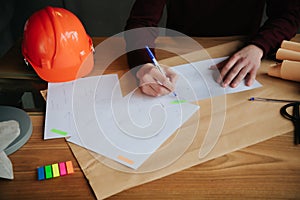 Concept architects,engineer holding pen pointing equipment architects On the desk with a blueprint in the office