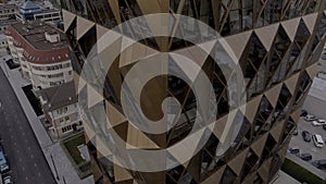 Concept of architecture. Stock footage. Russia, Ekaterinburg, aerial view of an unusual skyscraper of a brown color with