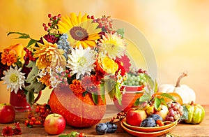 Concept of autumn festive decoration for Thanksgiving day. Autumn bouquet of flowers and berries in a pumpkin on a table,