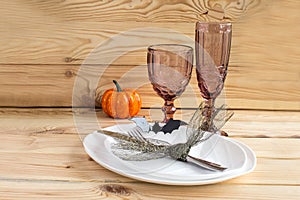 The concept of the autumn holidays. Traditional table setting for Halloween and Thanksgiving. Place for text.