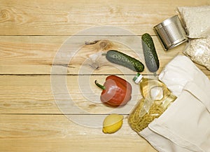 The concept of avoiding plastic bags, conscious consumption. Food in a cloth bag on a wooden background, top view, free space for