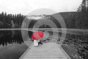 Concept of B&W photo with woman holding red umbrella