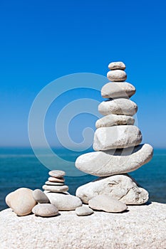 Concept of balance and harmony. White rocks zen on the sea