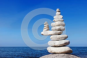 Concept of balance and harmony. White rocks zen on the sea.