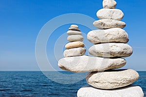 Concept of balance and harmony. White rocks zen on the sea. photo