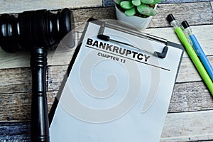 Concept of Bankruptcy Chapter 13 write on paperwork isolated on wooden background