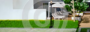 Concept banner for architecture and property. Headline copy space on left. Close up view of architectural model, deck chairs at