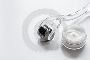 Concept beautician desktop with mezoroller - mesotherapy on white background