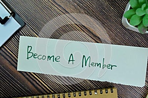 Concept of Become A member write on sticky notes isolated on Wooden Table