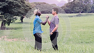 Concept of best friends,African man and asian man handshake with smile and happy