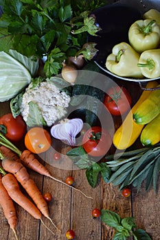 Concept bio organic food. Ingredients for healthy cooking. Vegetables and herbs on wooden background. Preparation of dishes from a