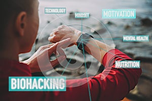 Concept of Biohacking, Modern Technology in Health and Sports. Woman Uses a Smartwatch on Her Hand to Train Healthy Lifestyle,