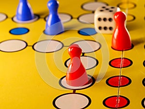 The concept of board games. Dice, chips and cards on a yellow background