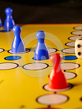 The concept of board games. Dice, chips and cards on a yellow background