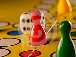 The concept of board games. Dice, chips and cards on a yellow background