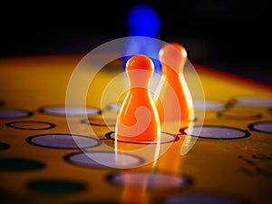 The concept of board games. Dice, chips and cards on a yellow background