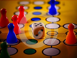 The concept of board games. Dice, chips and cards on a yellow background photo