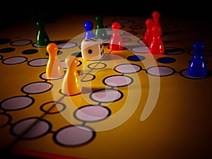 The concept of board games. Dice, chips and cards on a yellow background photo