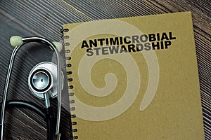 Concept of a book Antimicrobial Stewardship isolated on Wooden Table